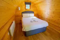 Camping pod interior with a double bed at Chestnut Meadow Camping and Glamping