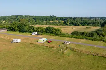 Aerial of the electric grass pitches with countryside views
