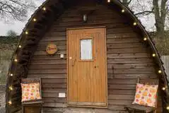 Camping pod with a small wooden porch area