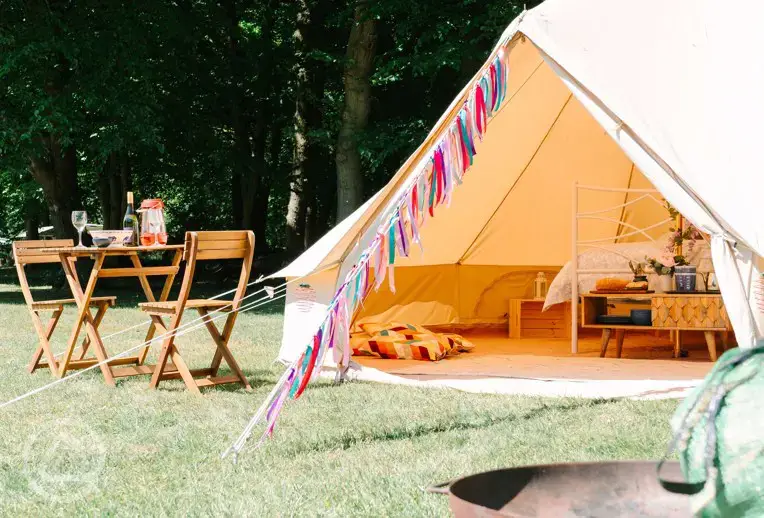 Bell tent with a private fire pit and outdoor seating area