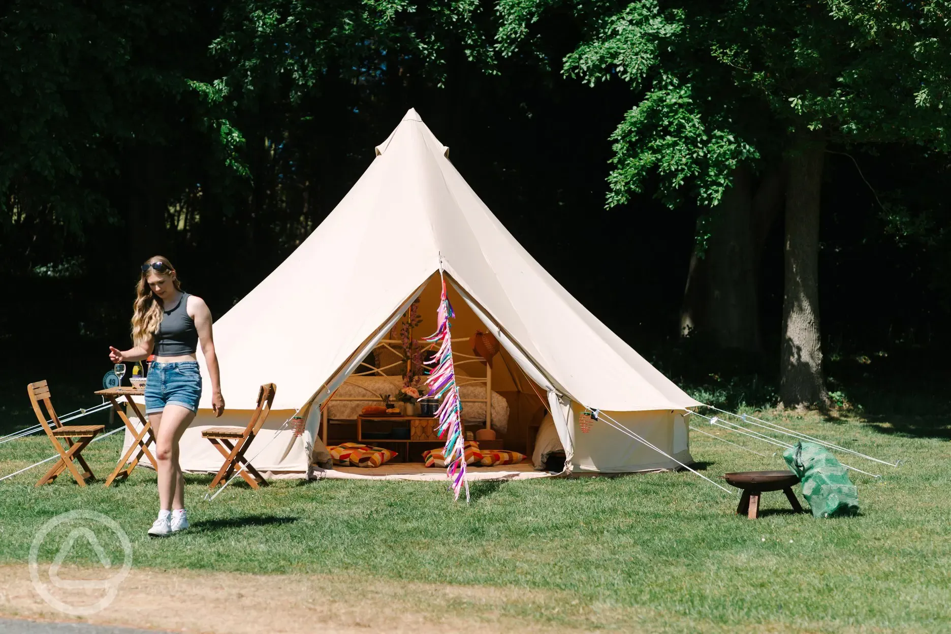 Bell tent with a private fire pit and outdoor seating area