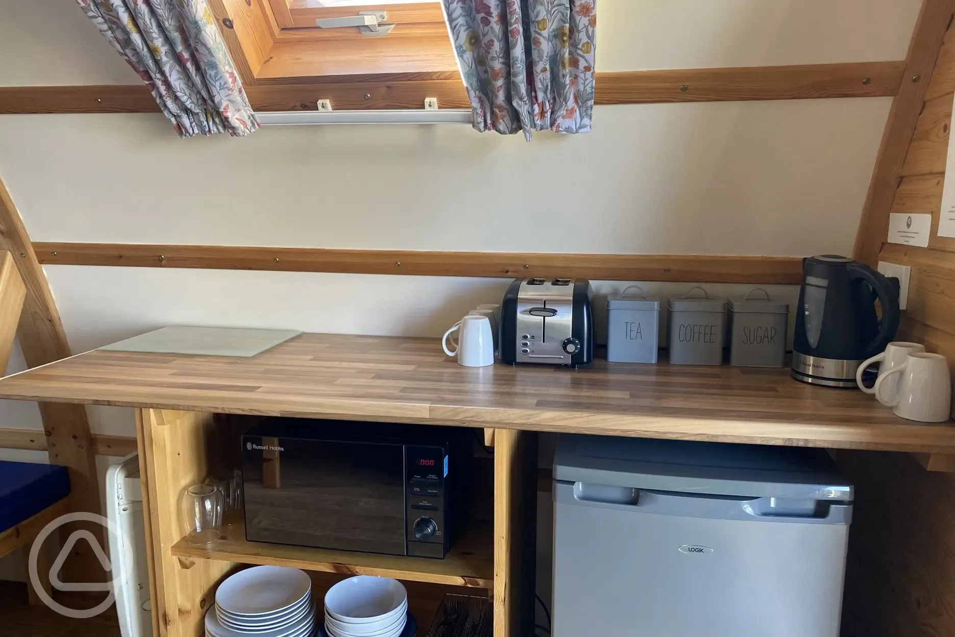 Camping pod with a fridge, microwave, kettle, toaster, cutlery and crockery