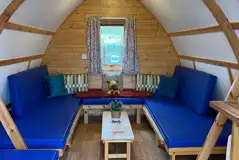 Camping pod interior with sofas