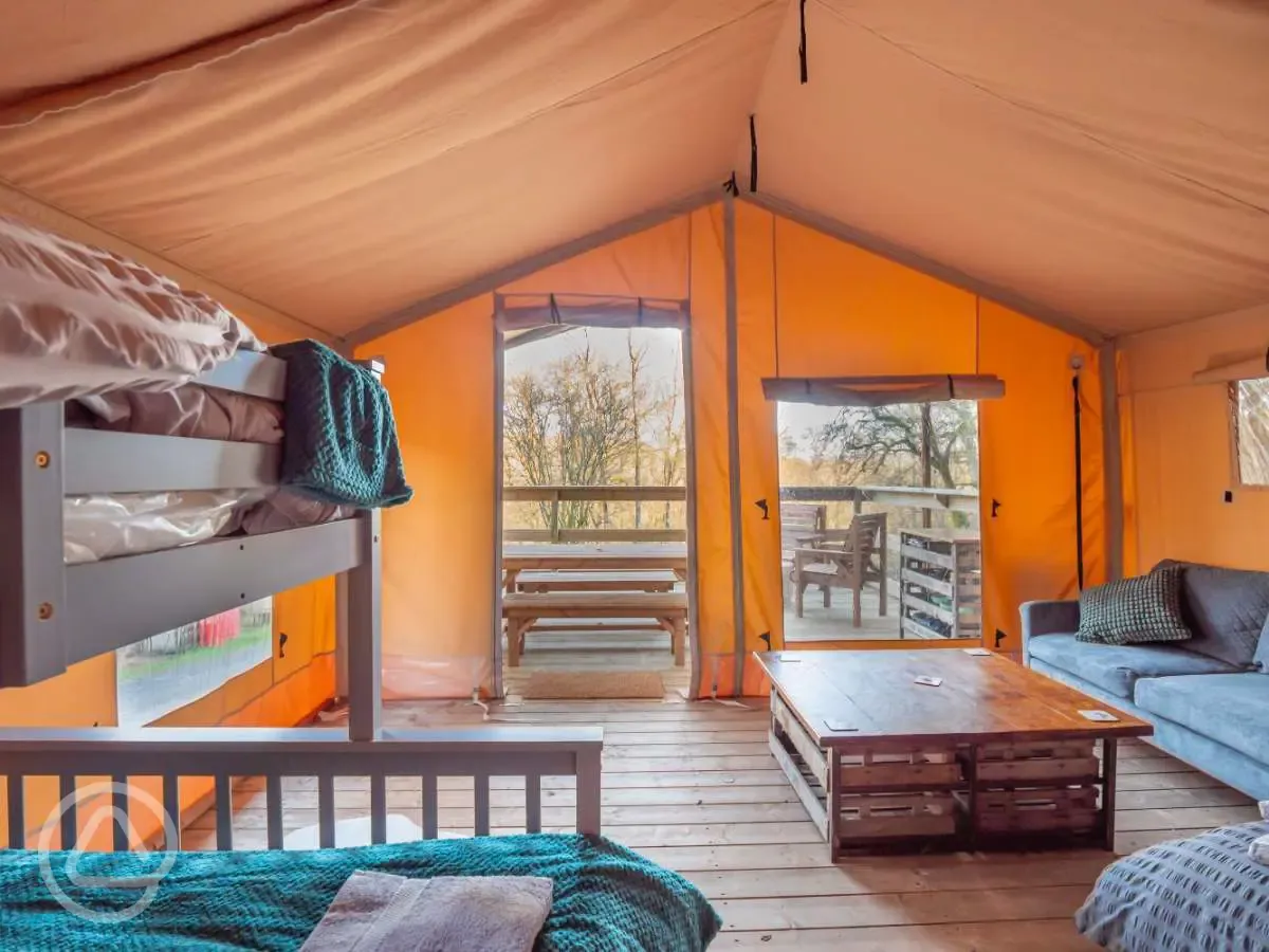 Safari tent interior seating area with views of the decking