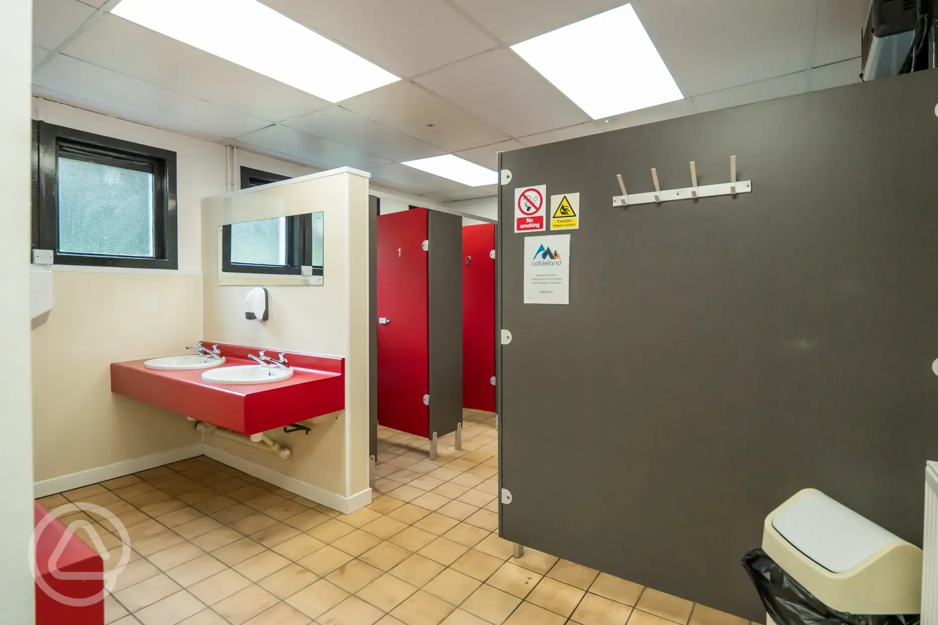 Site toilets and showers with cubicles, sinks, hooks and mirrors