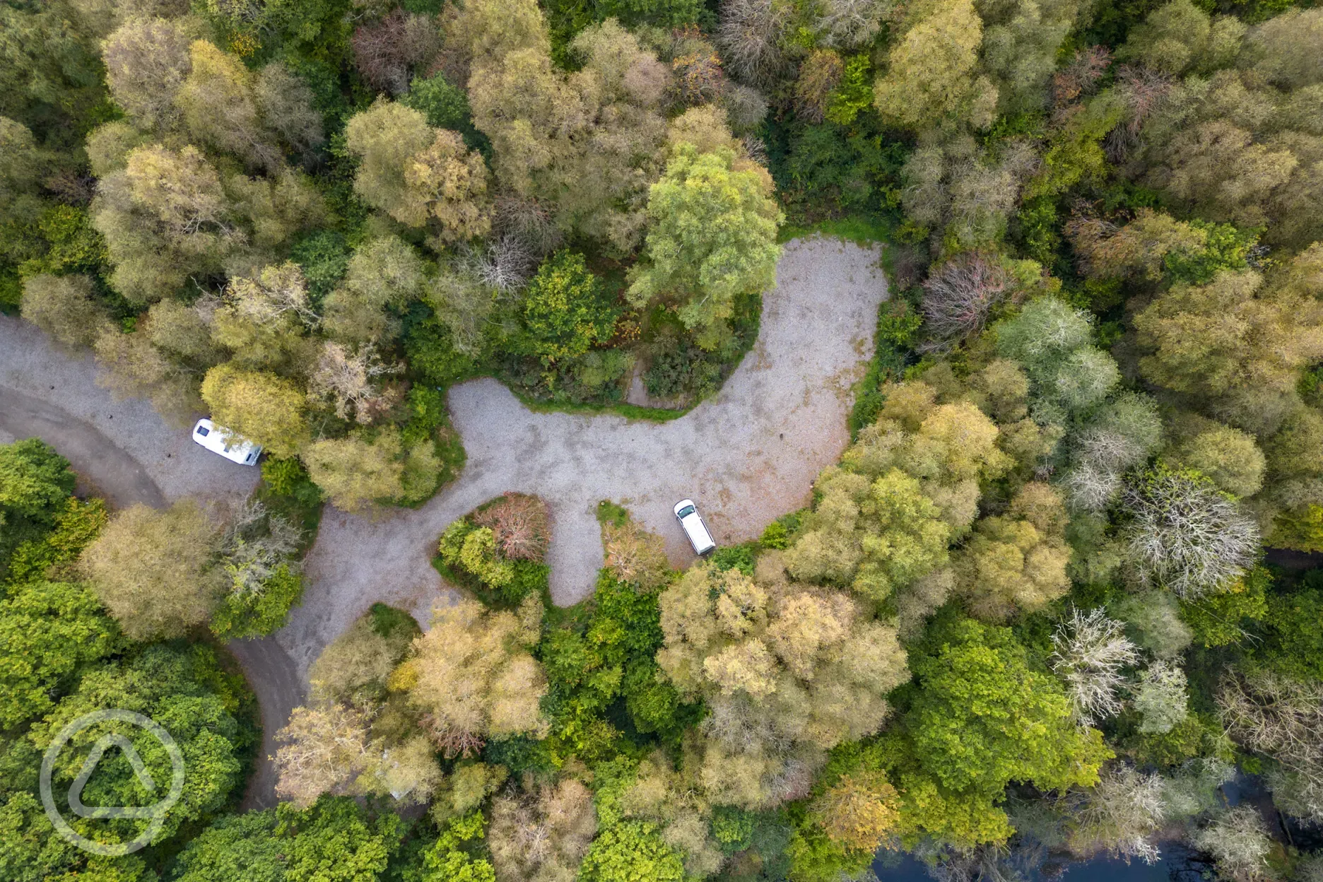 Aerial of gravel pitches surrounded by trees