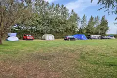 Non electric grass tent pitches with space to park one car alongside