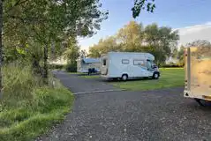 Electric hardstanding pitches surrounded by trees