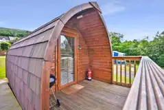 Exterior view of the Log Pods (dog friendly) with an outdoor BBQ Exterior view of the Log Pods (dog friendly) with an outdoor BBQ