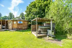 Wooden cabin with a private, sheltered wood-fired hot tub