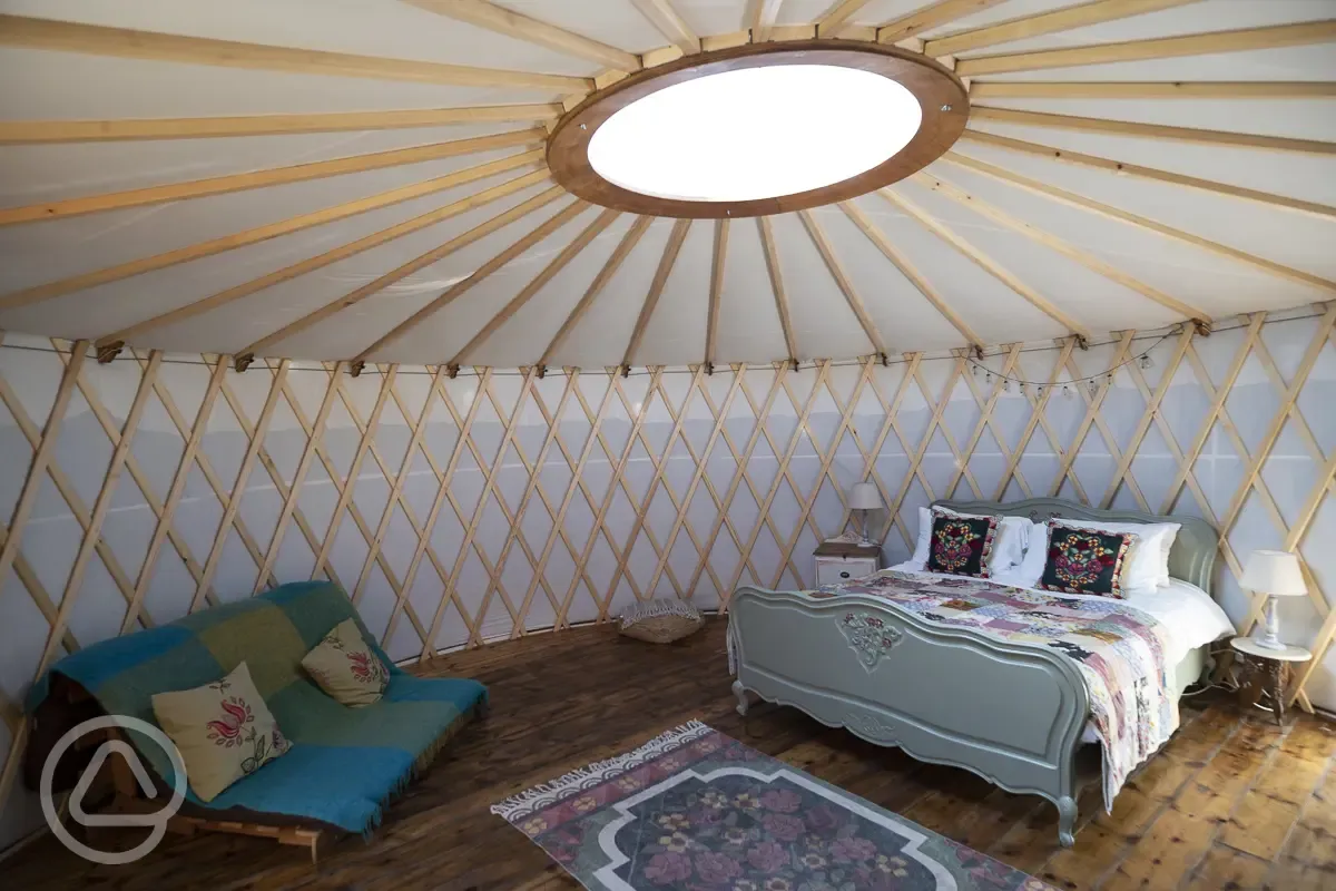 Croglin yurt interior with a double bed and futon