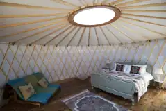 Croglin yurt interior with a double bed and futon
