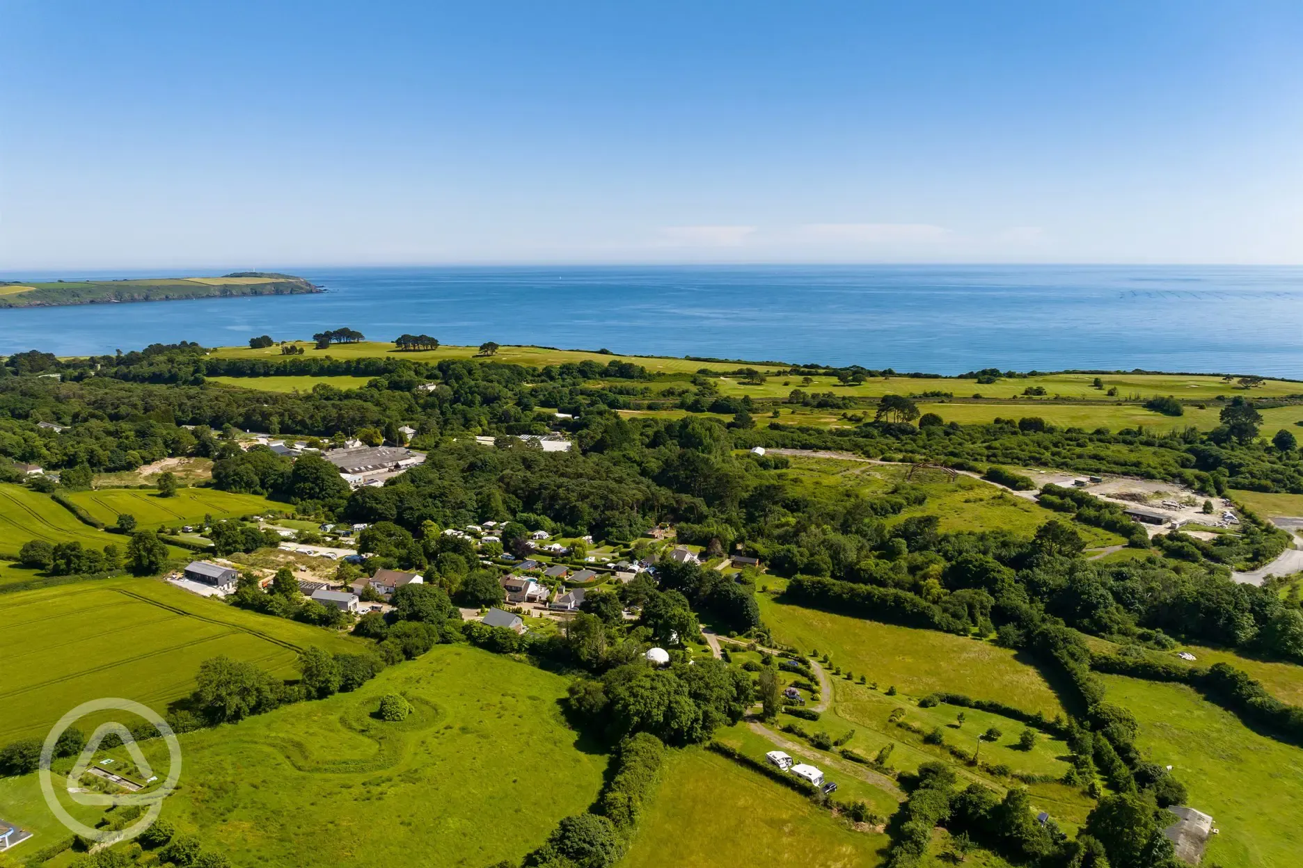 Aerial view of East Crinnis Holiday Park, towards the coast and Carlyon Bay