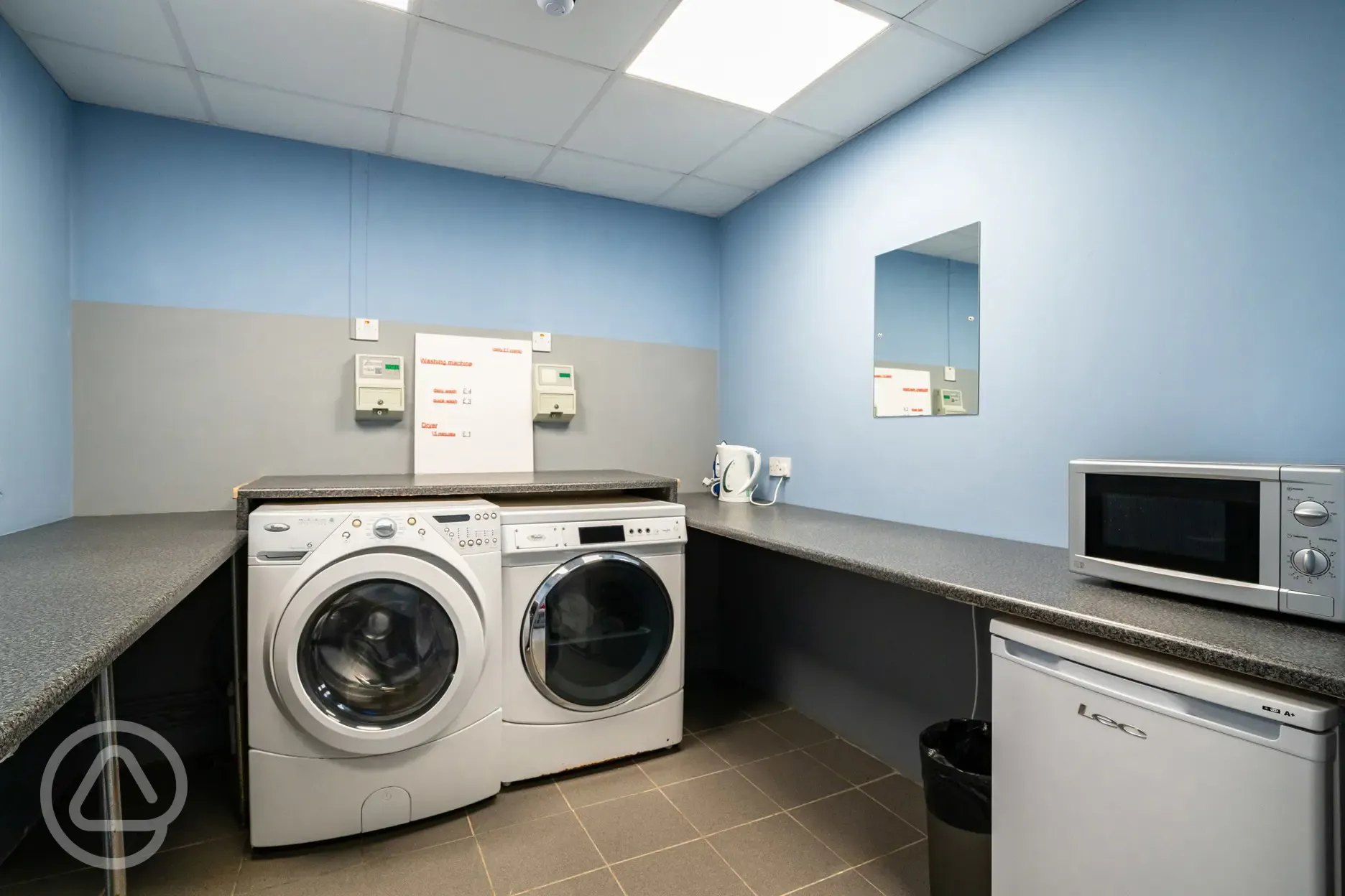 Laundry room with coin-operated washing machines and tumble dryers