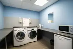 Laundry room with coin-operated washing machines and tumble dryers