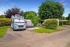 Electric hardstanding pitches with hedges for privacy