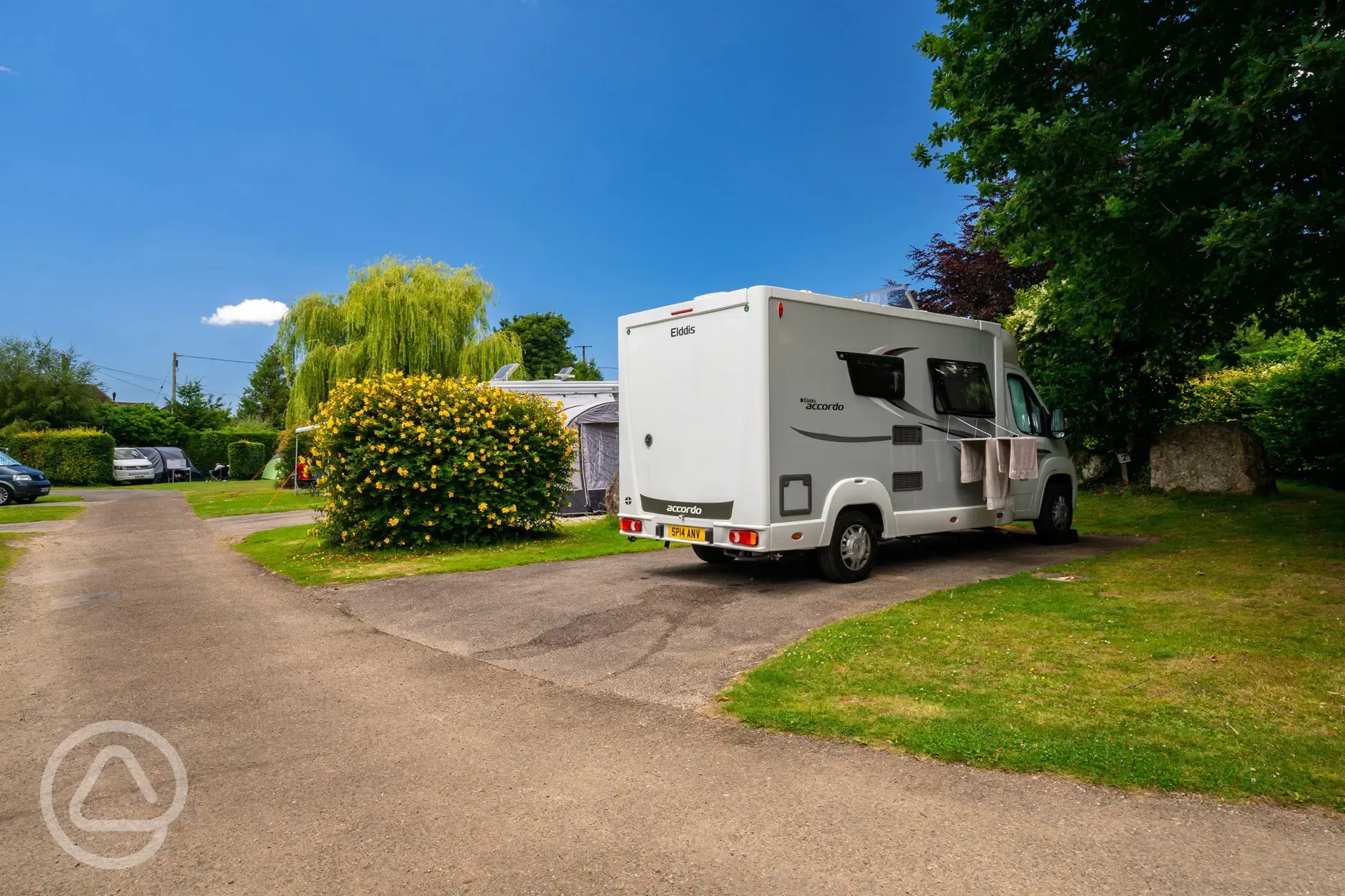 Electric hardstanding pitches with hedges for privacy