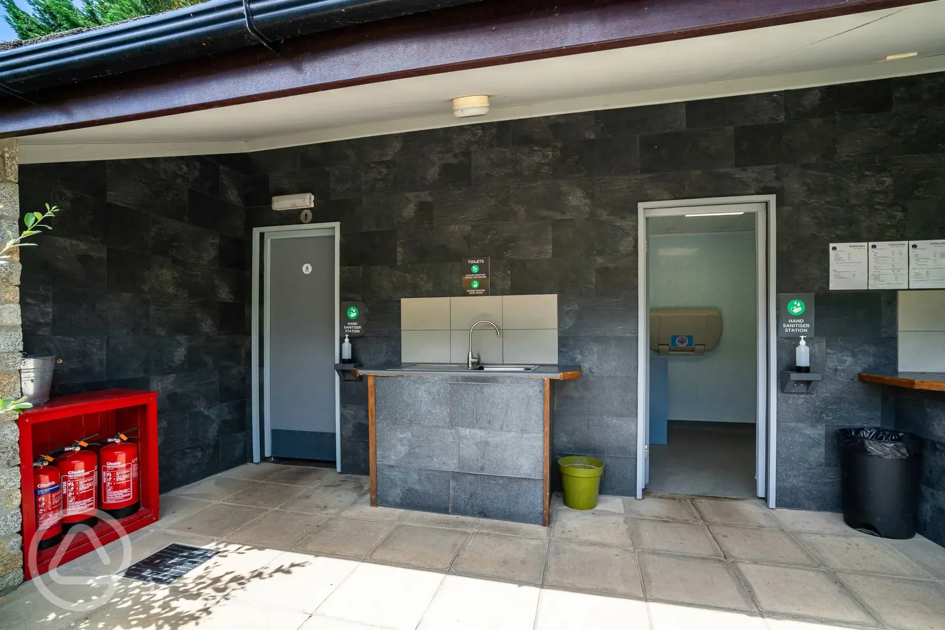 Facilities block with male and female bathrooms, plus an outdoor washing up sink