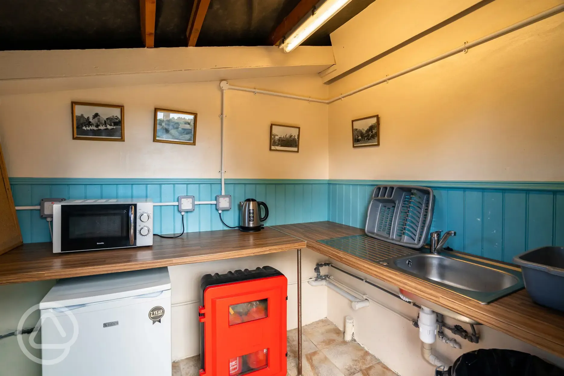 Kitchen area with access to a freezer and microwave