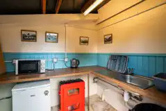 Kitchen area with access to a freezer and microwave