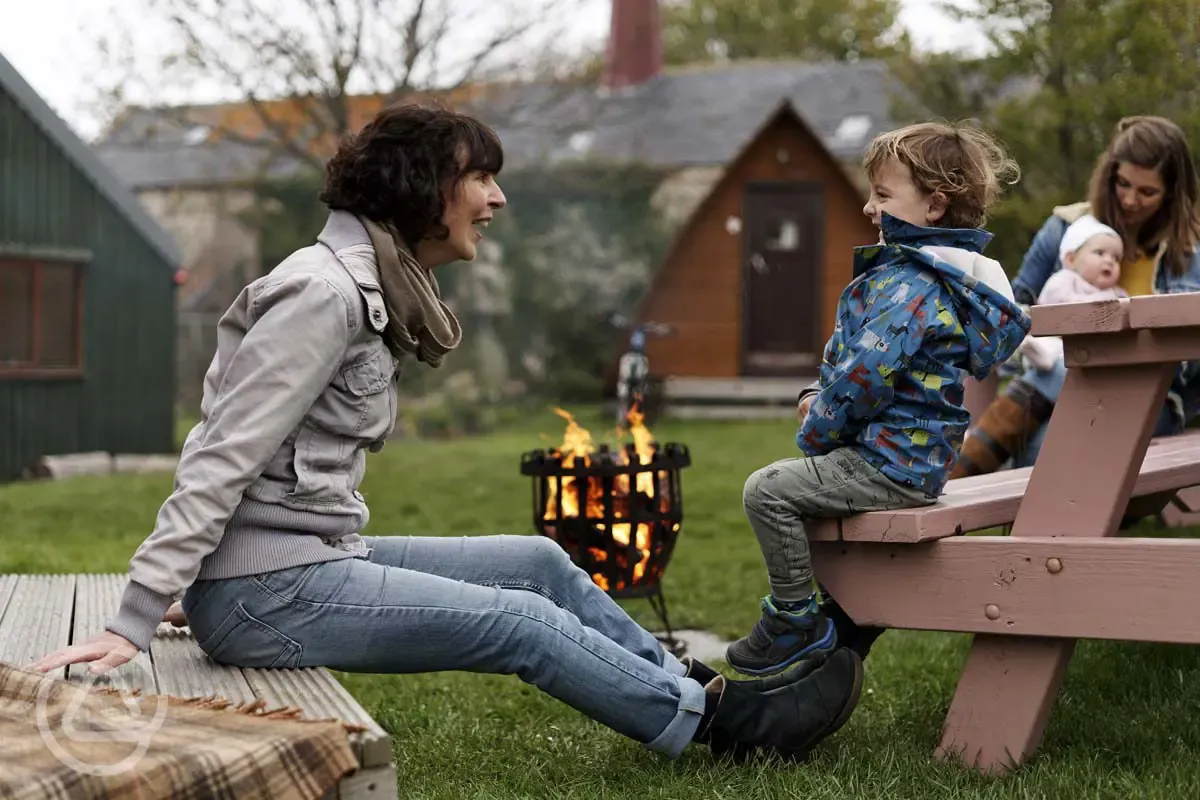 Original pod picnic benches and fire pits at The Loft
