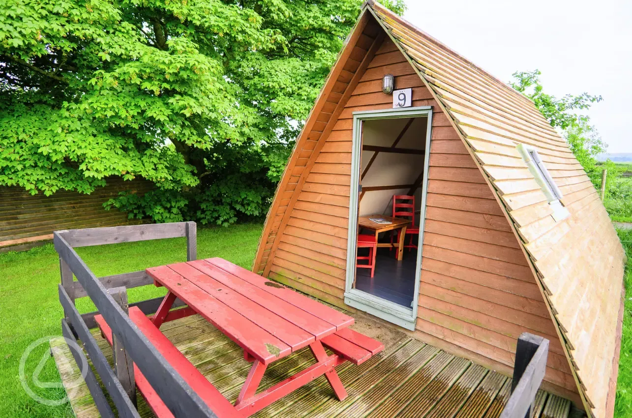 Original camping pod with private decking at picnic bench at The Loft