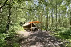 Wild glamping bell tent with a canopy and picnic table