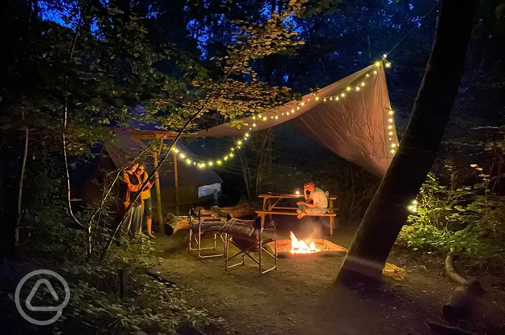 Communal campfire area at night