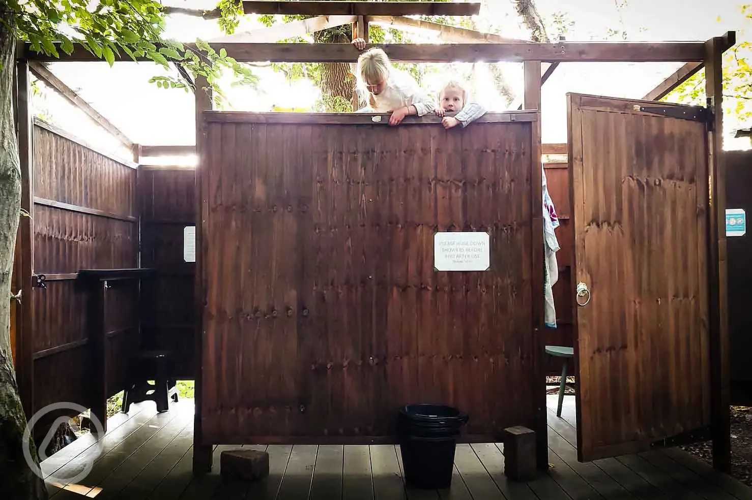 Children playing in the bucket showers