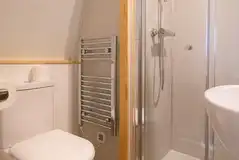 Eco pod ensuite with a toilet, shower, hand basin and towel rail Eco pod ensuite with a toilet, shower, hand basin and towel rail