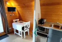 Eco pod with a TV, small dining area and kitchenette Eco pod with a TV, small dining area and kitchenette