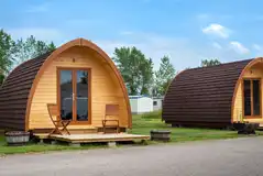 Eco glamping pods with small deck areas and furniture Eco glamping pods with small deck areas and furniture
