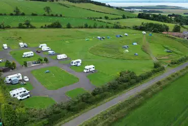 Aerial of the grass and hardstanding pitches at Forth House Caravan Site