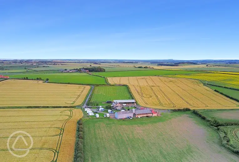 Aerial view of Bamburgh Touring Caravans at Fowberry Farm and surrounding fields