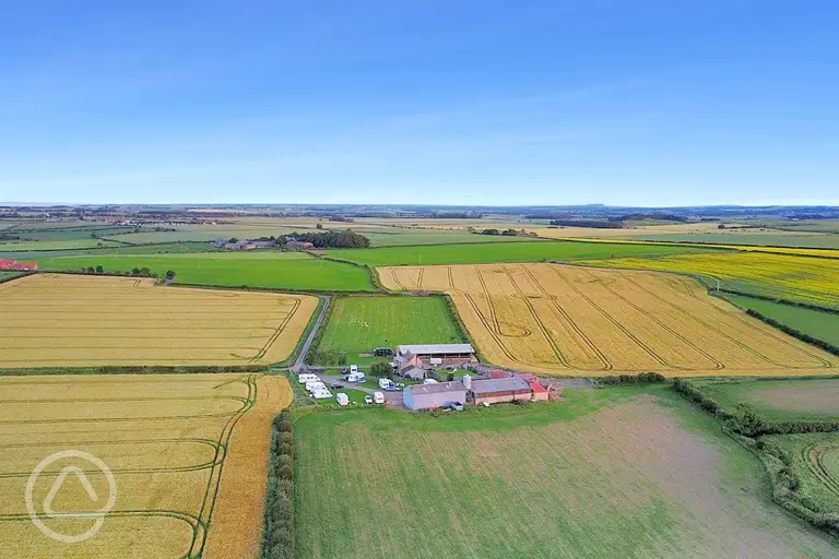 Aerial view of Bamburgh Touring Caravans at Fowberry Farm and surrounding fields