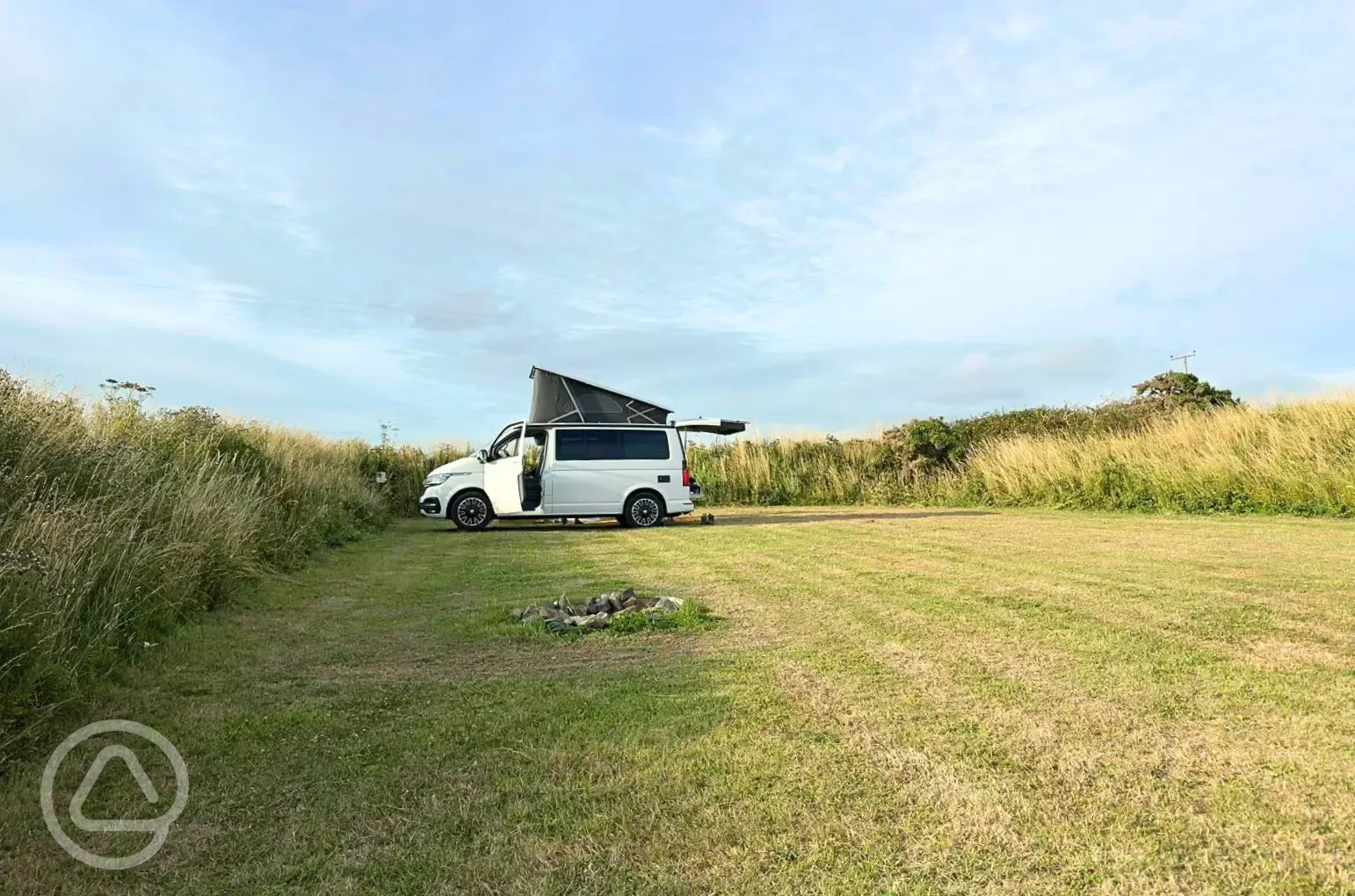 Grass pitches with optional electric, picnic benches and fire pits