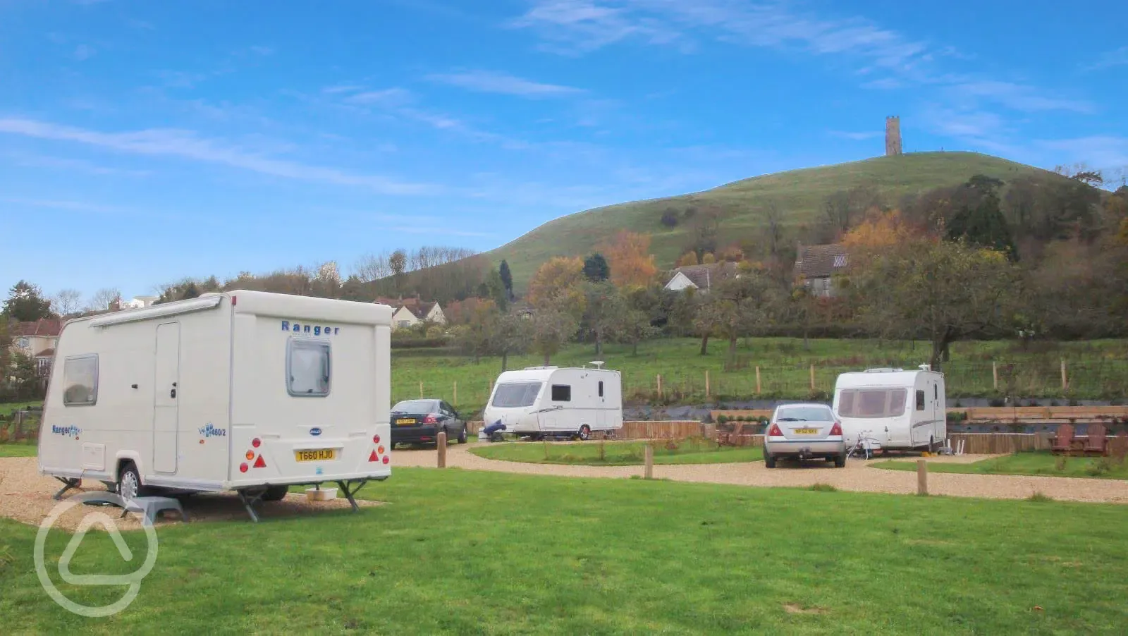 Electric hardstanding pitches with view of the Glastonbury Tor