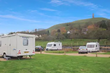 Electric hardstanding pitches with view of the Glastonbury Tor