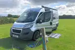 Campervan on an electric grass pitch with a 16 amp hook up 
