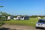 Grass pitches with space for a parked car