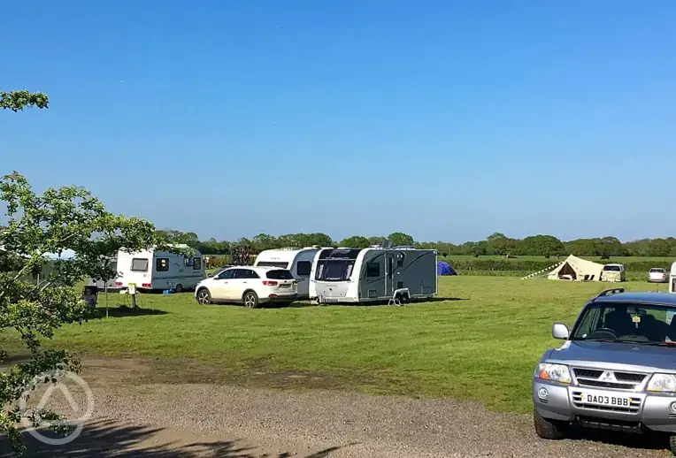 Grass pitches with space for a parked car