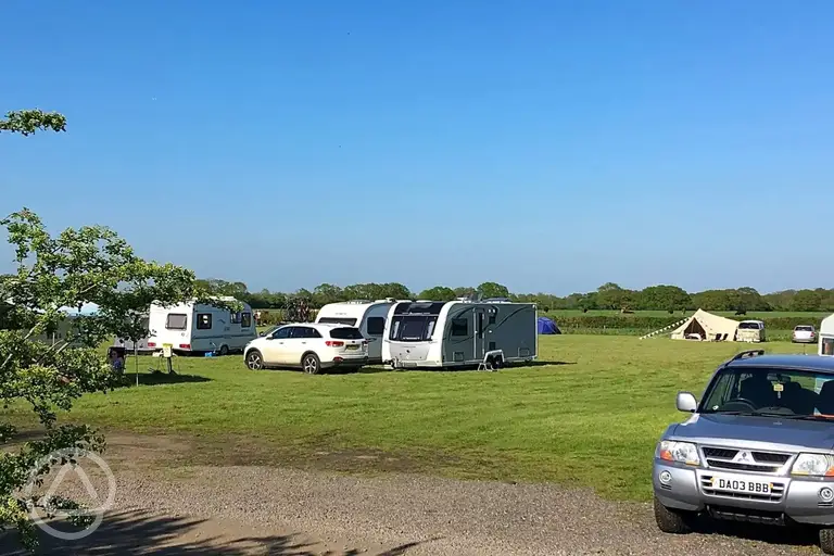 Grass pitches with space for a parked car