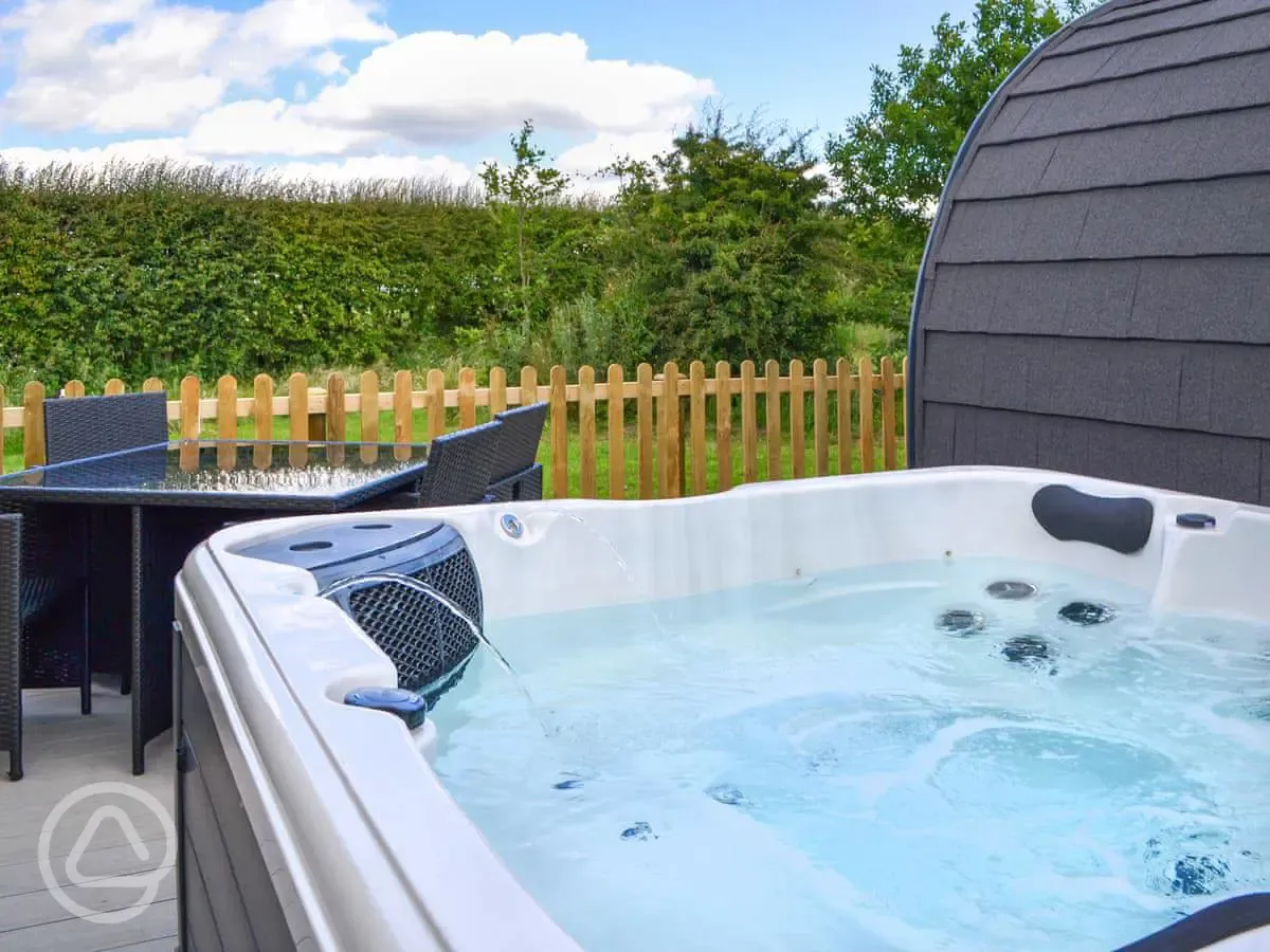Private hot tub and seating area with table and chairs