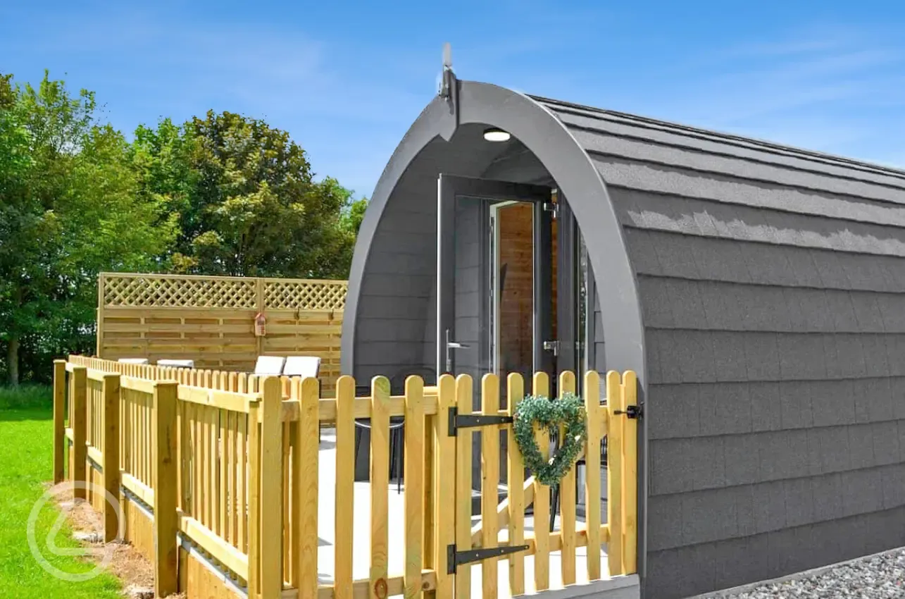Glamping pod with fenced access and a gate entrance