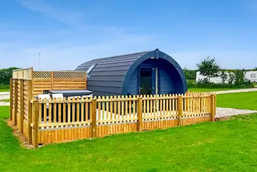 Ensuite glamping pod with a fenced-off private decked area and a hot tub