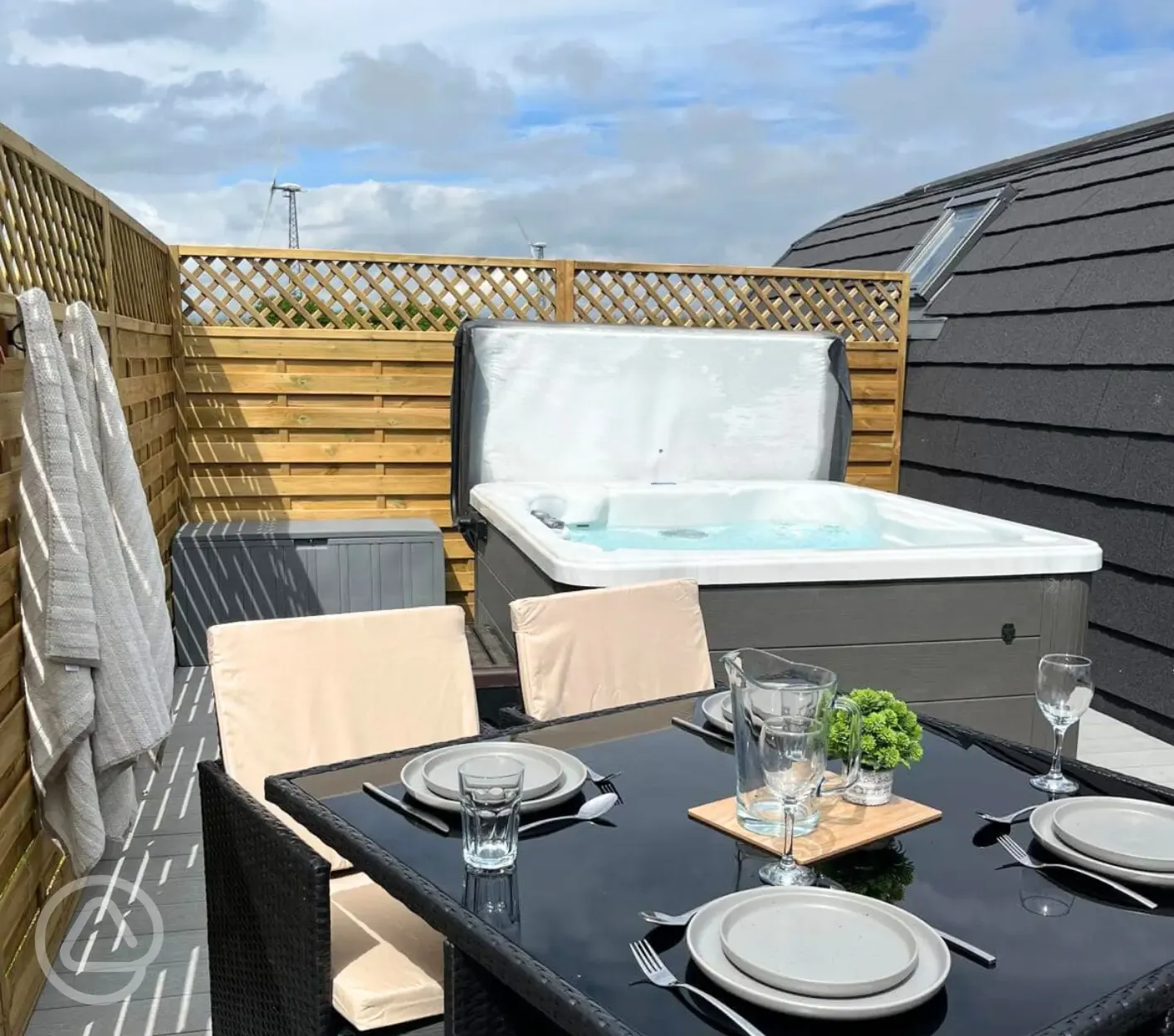 Private hot tub and seating area with table and chairs