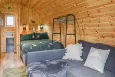 Glamping pod interior with a double bed and double sofa bed (bedding included) Glamping pod interior with a double bed and double sofa bed (bedding included)