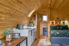 Ensuite glamping pod interior with a double bed and double sofa bed Ensuite glamping pod interior with a double bed and double sofa bed