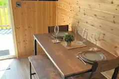Ensuite glamping pod dining area and TV