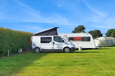 Grass pitches with 16 amp electric hook ups at Graffitoe Farm